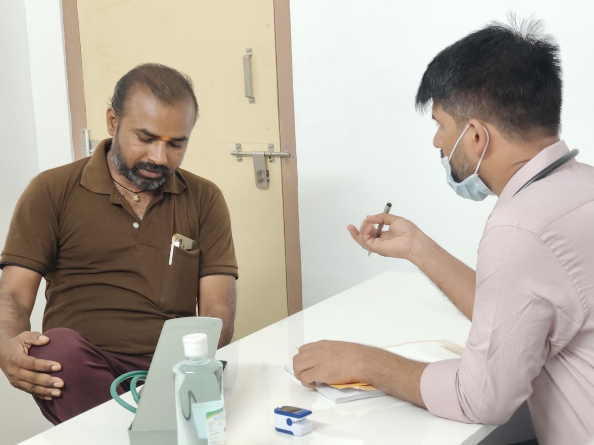 A doctor consulting a patient in a consultation room at Aditya Hrudayalaya
